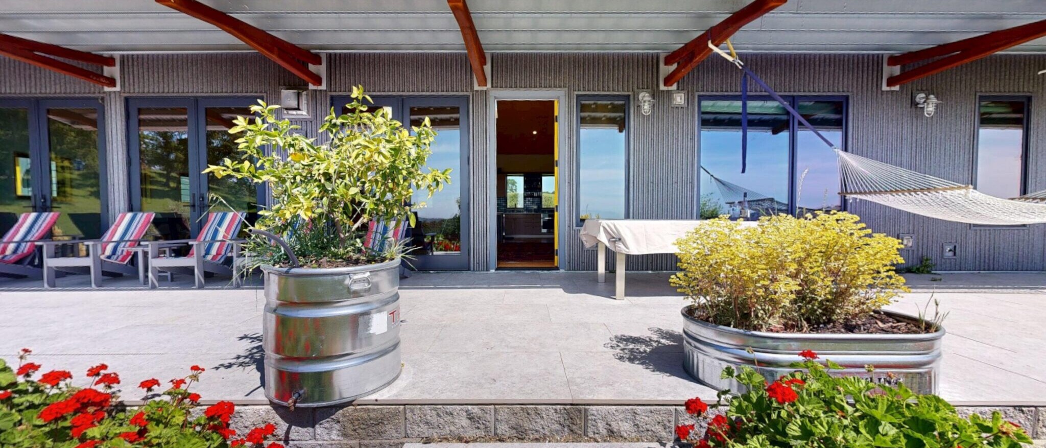 Spacious outdoor patio and living area at a custom Napa home built by Black Creek Builders, featuring modern design, planters, and comfortable seating.