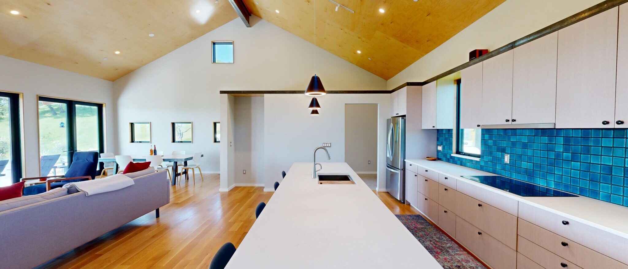 Spacious open-concept kitchen and living area in a custom Napa home, built by Black Creek Builders, featuring a long island and bright wood finishes.