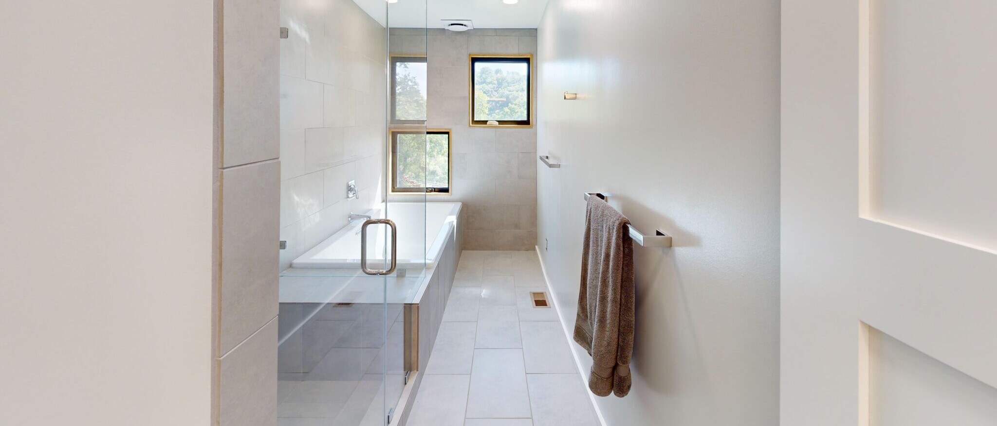 Modern bathroom with walk-in shower and minimalist tub in a custom Napa home, built by Black Creek Builders, featuring clean lines and natural light.