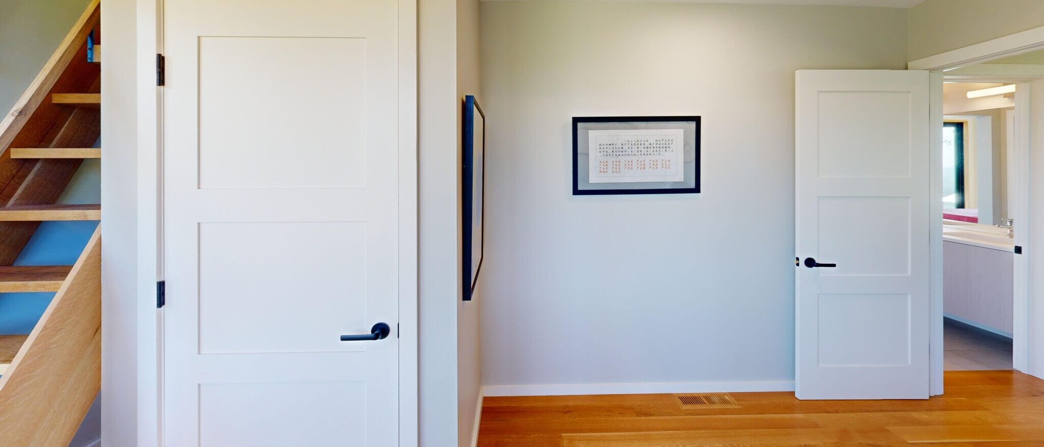 Modern interior hallway with custom staircase and panel doors in a Napa home built by Black Creek Builders, showcasing residential finishes.
